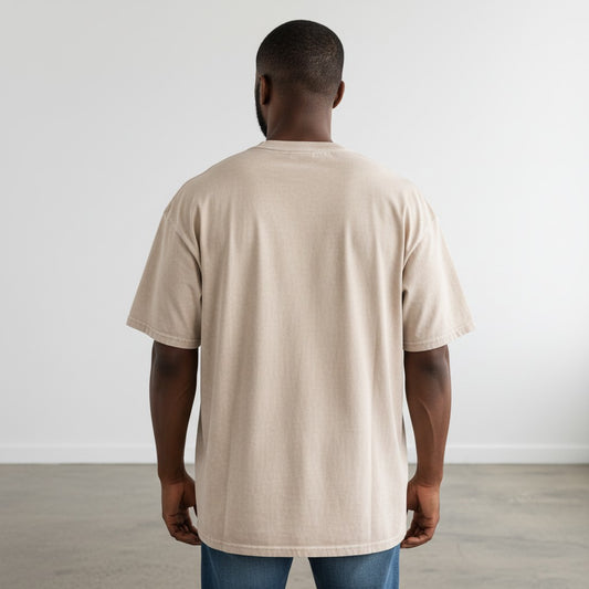 Back view of a man wearing a BREAKPOINT Sportswear apricot oversized cotton t-shirt with a vintage snow-wash finish.