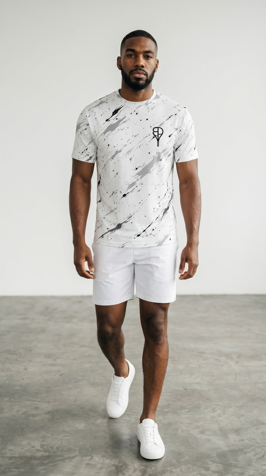 BREAKPOINT Splatter Strike White Performance Tee — white tennis and golf tee with black splatter print