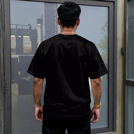 BREAKPOINT Sportswear unisex black drop-shoulder t-shirt with relaxed fit worn by a man from the back view.