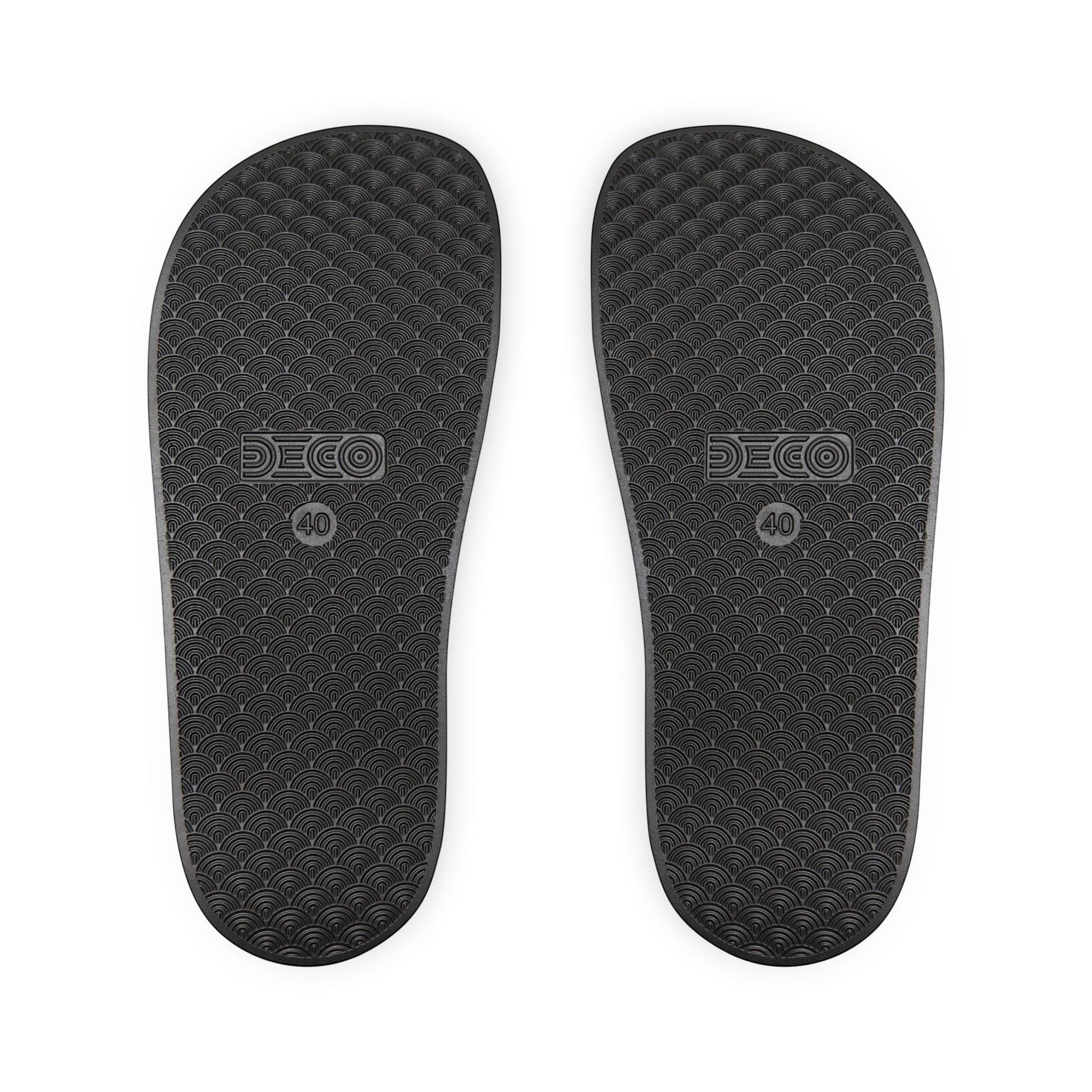 BREAKPOINT Sportswear black golf slides showing the textured, water-friendly PU-foam sole with a wave pattern.