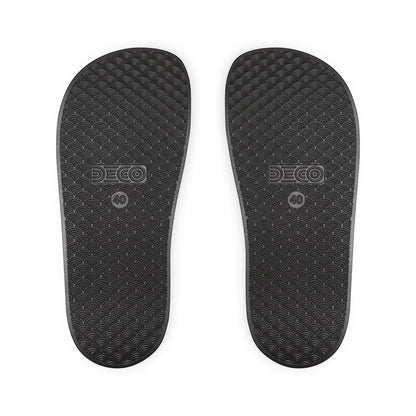 BREAKPOINT Sportswear black golf slides showing the textured, water-friendly PU-foam sole with a wave pattern.