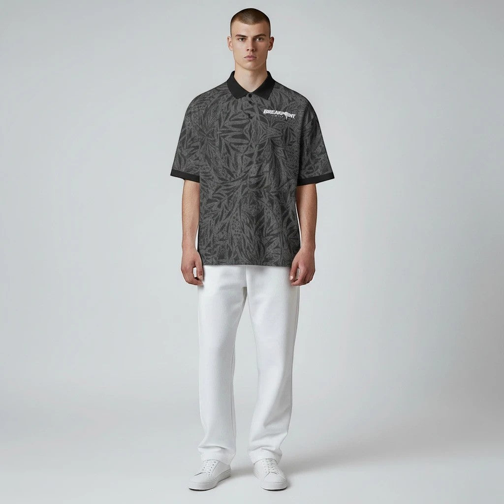 BREAKPOINT Sportswear black polo shirt with 90s-inspired all-over leaf print, three-button collar, and regular fit.