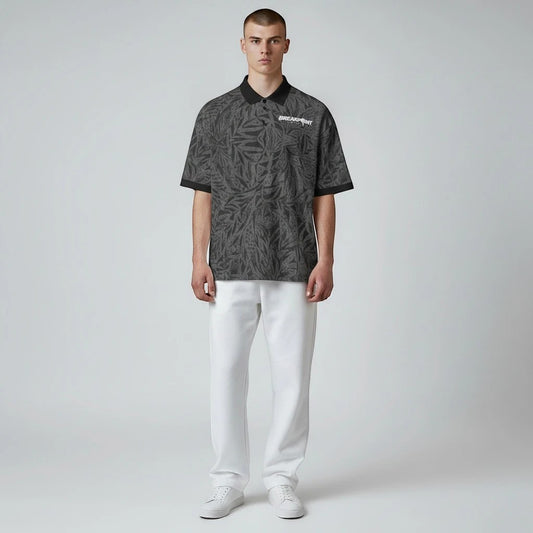 BREAKPOINT Sportswear black polo shirt with 90s-inspired all-over leaf print, three-button collar, and regular fit.