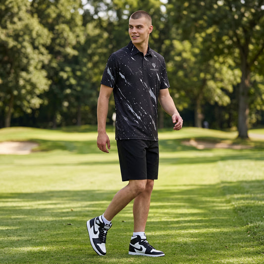 BREAKPOINT Sportswear men's black heavyweight polyester polo with white splatter print, worn by a golfer on a course.