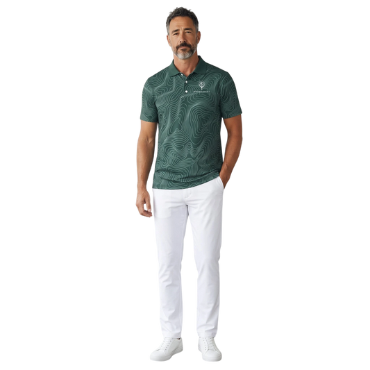 BREAKPOINT Sportswear forest green performance polo with topographic print, worn by a man with white golf trousers.
