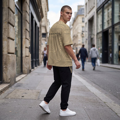 BREAKPOINT Sportswear gold and black drop-shoulder tee with topographic line print worn by a man on a city street.