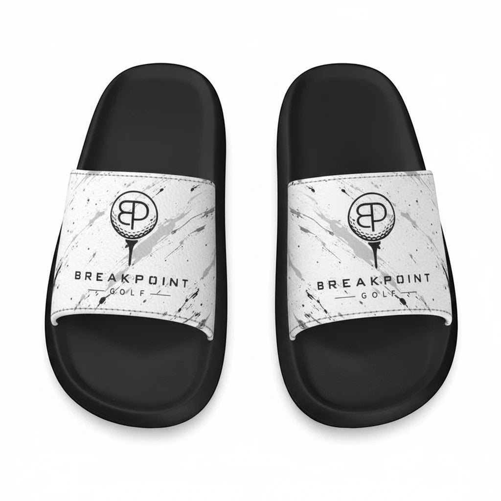 BREAKPOINT Sportswear slides featuring white straps with black splatter and logo.