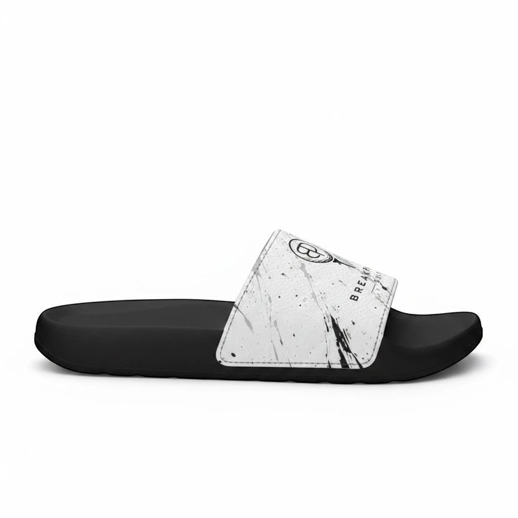 BREAKPOINT Sportswear golf slides with a white paint-splatter removable strap and black lightweight PU-foam sole.