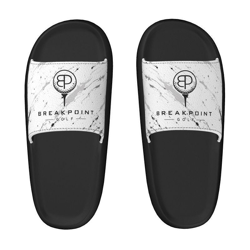 BREAKPOINT Sportswear golf slides with white removable straps featuring a black splatter pattern and logo.