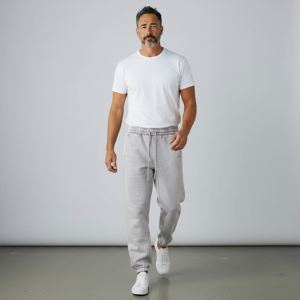 Man wearing BREAKPOINT Sportswear grey fleece sweatpants with elastic waistband and cuffed ankles in a studio setting