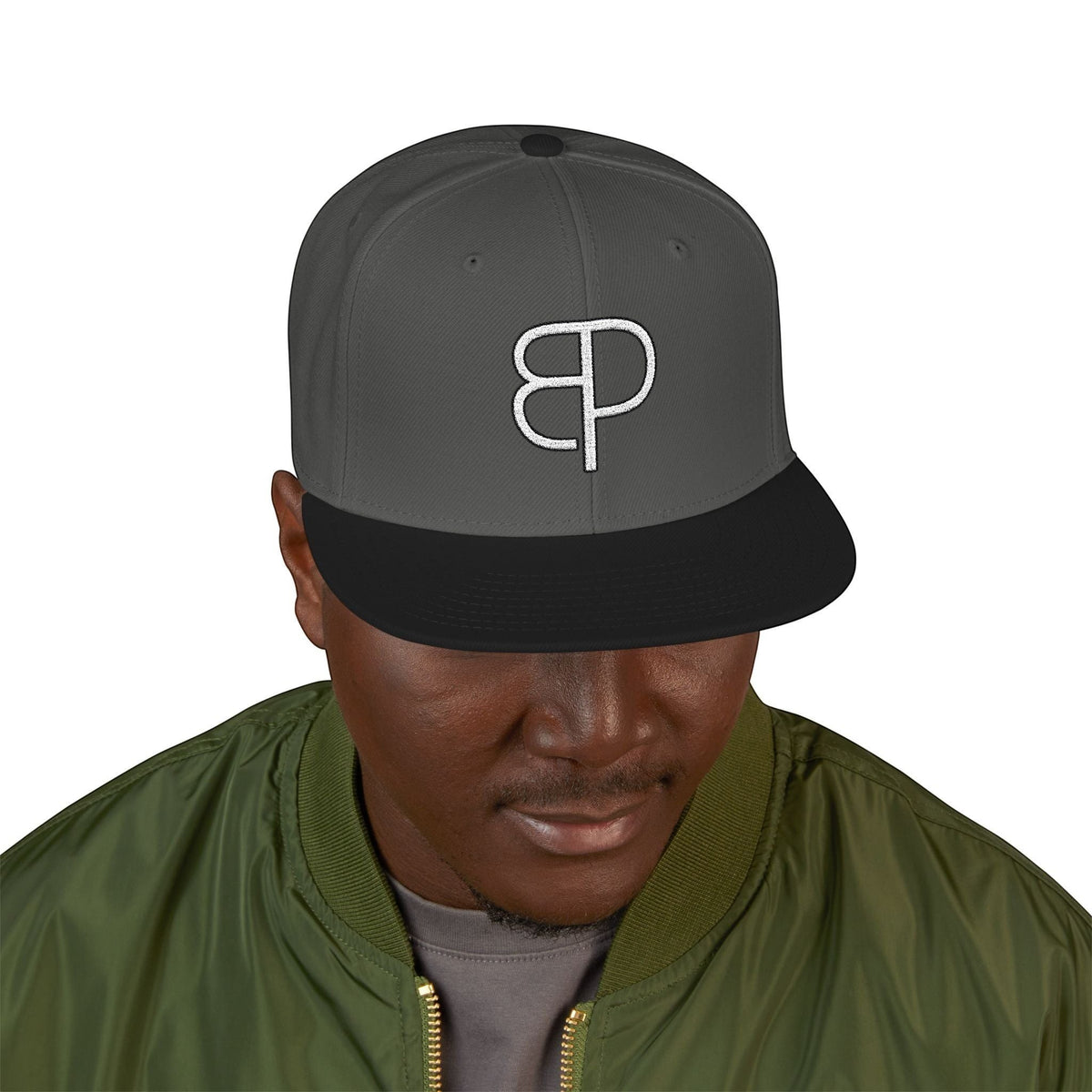 A man wearing a grey BREAKPOINT Sportswear high-profile snapback cap with a flat visor and white logo embroidery.