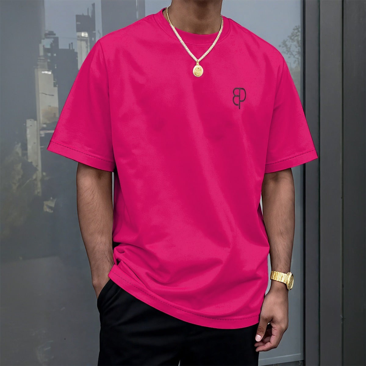 BREAKPOINT Sportswear hot pink drop shoulder tee on a male model wearing black joggers and white sneakers