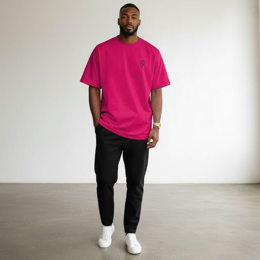 BREAKPOINT Sportswear hot pink drop shoulder tee on a male model wearing black joggers and white sneakers