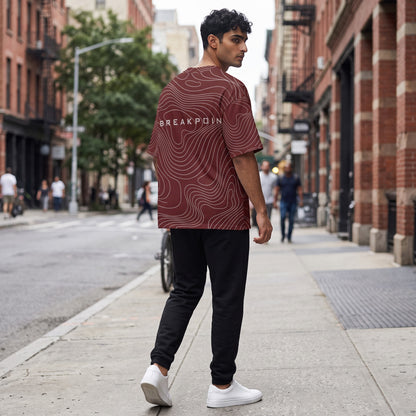 BREAKPOINT Sportswear maroon drop-shoulder tee with white topographic line print worn by a man on a city street.