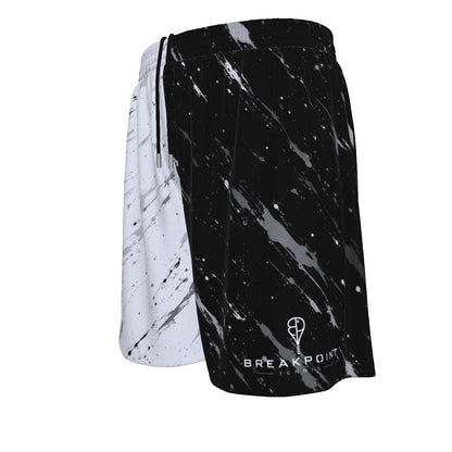 BREAKPOINT Sportswear men's athletic mesh shorts featuring a black and white paint splatter all-over print design.