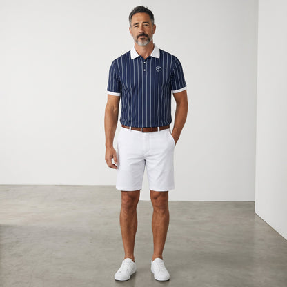 BREAKPOINT Sportswear men's navy blue pinstripe polo shirt with white collar and cuffs, worn with white shorts.