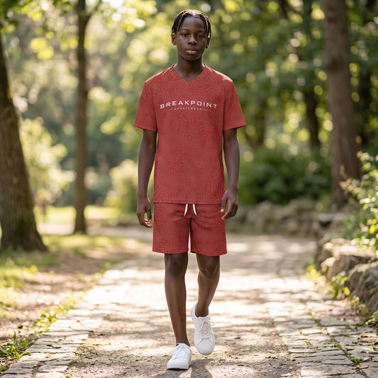 BREAKPOINT Sportswear youth match set featuring a red V-neck tee and shorts with a white topographic line print