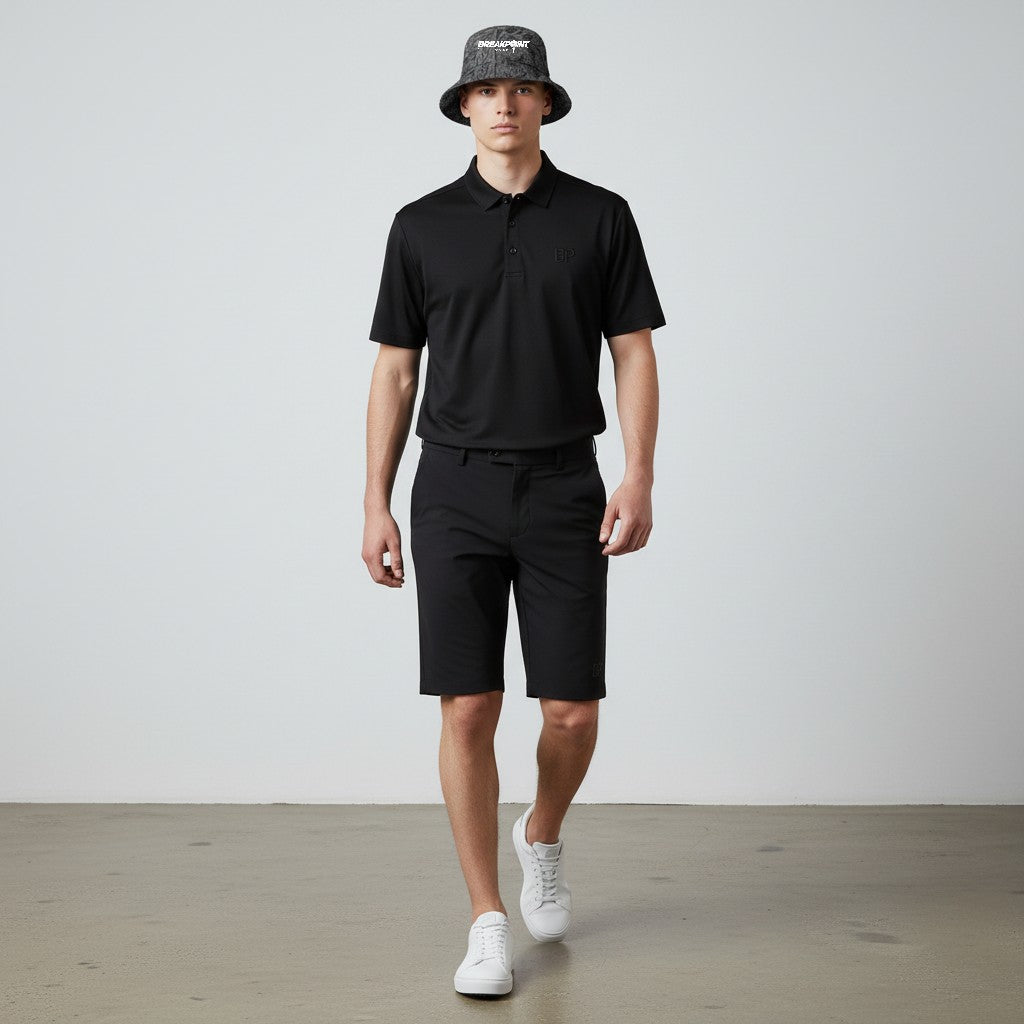 BREAKPOINT Sportswear reversible bucket hat with golf print worn by a male model in a black polo and shorts