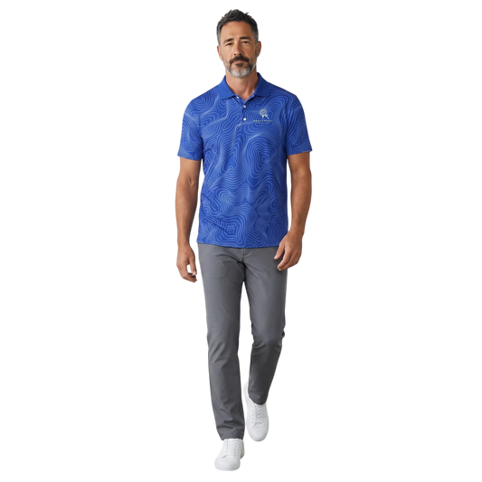 A man wearing a BREAKPOINT Sportswear royal blue performance polo with a white topographic print and three-button collar.