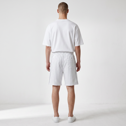 BREAKPOINT Sportswear unisex white court shorts with black pinstripes, featuring a loose fit and back pocket, rear view