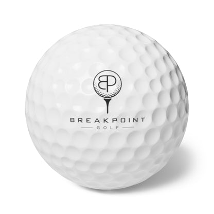 BREAKPOINT Sportswear white golf ball with dimpled surface and black BREAKPOINT GOLF logo branding