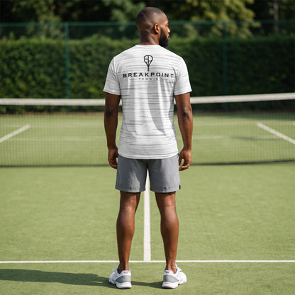 BREAKPOINT Sportswear white performance tee with static print worn by a man on a tennis court from the back view.