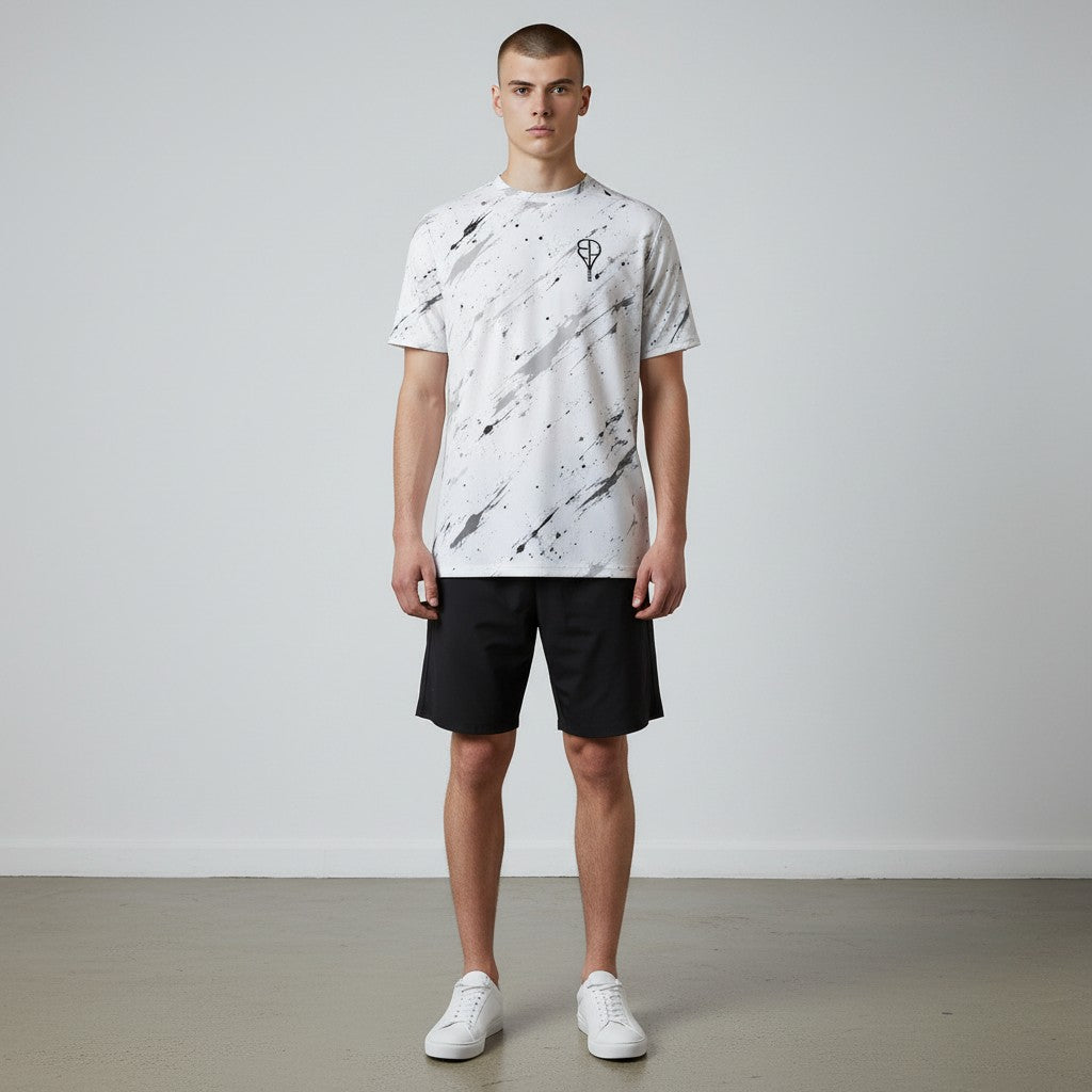 BREAKPOINT Sportswear white tennis t-shirt with black splatter print, moisture-wicking performance knit, and crew neck.