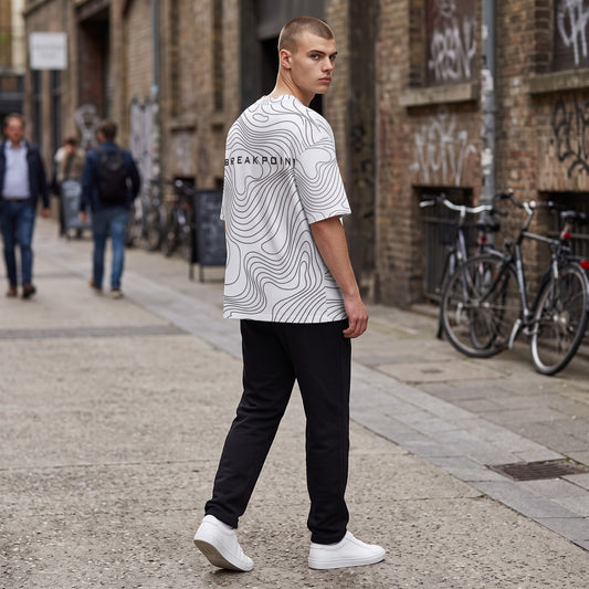 BREAKPOINT Sportswear white drop-shoulder tee with black topographic line print worn by a man in an urban setting.